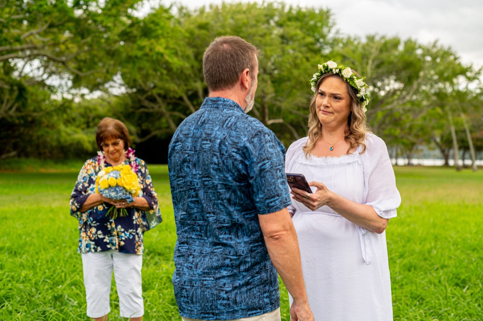 An elopement ceremony on the lawn at Kualoa, two people and the officiant