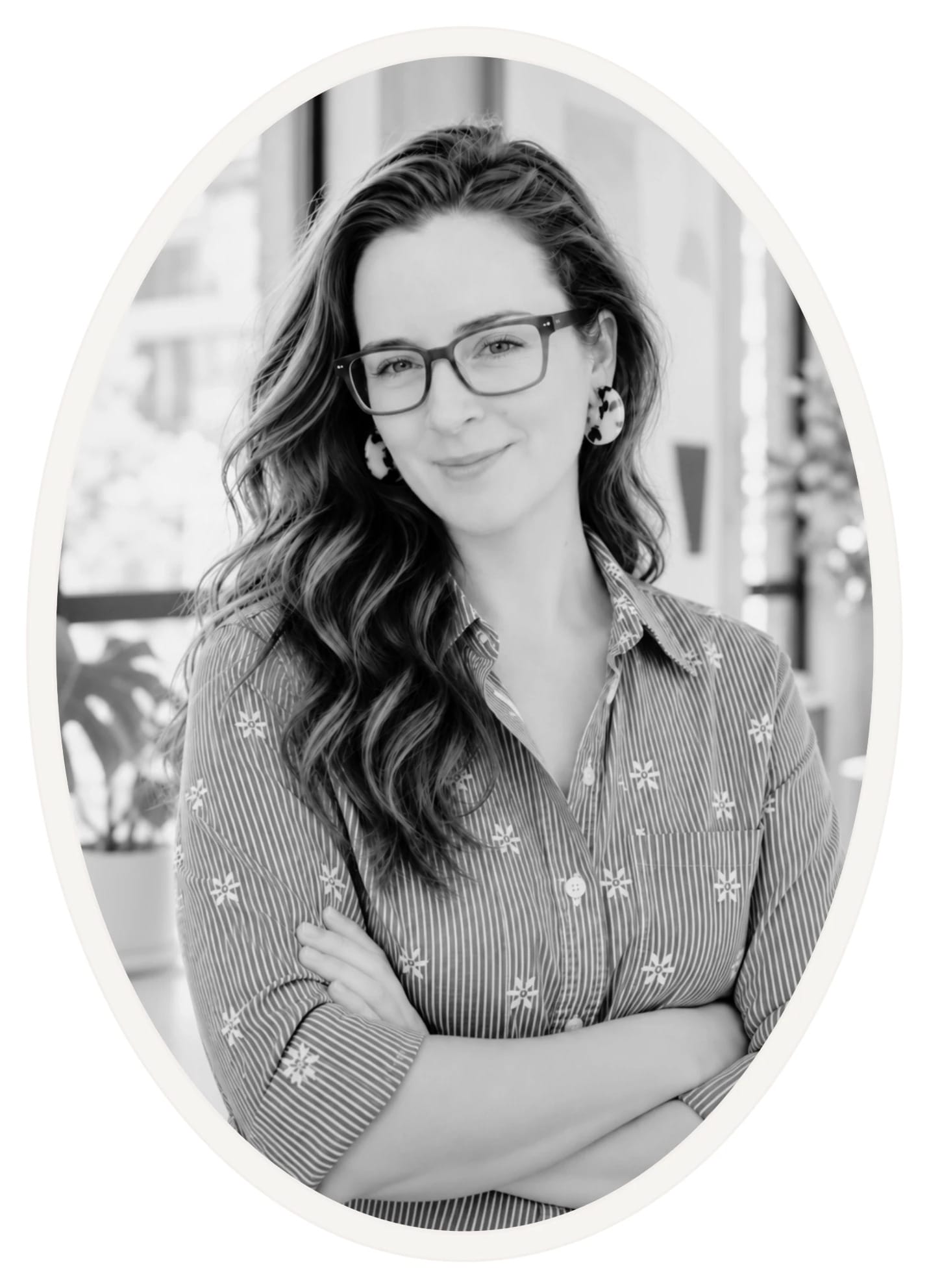 Daniella, the photographer behind Elopefully & Co., in a black and white oval portrait