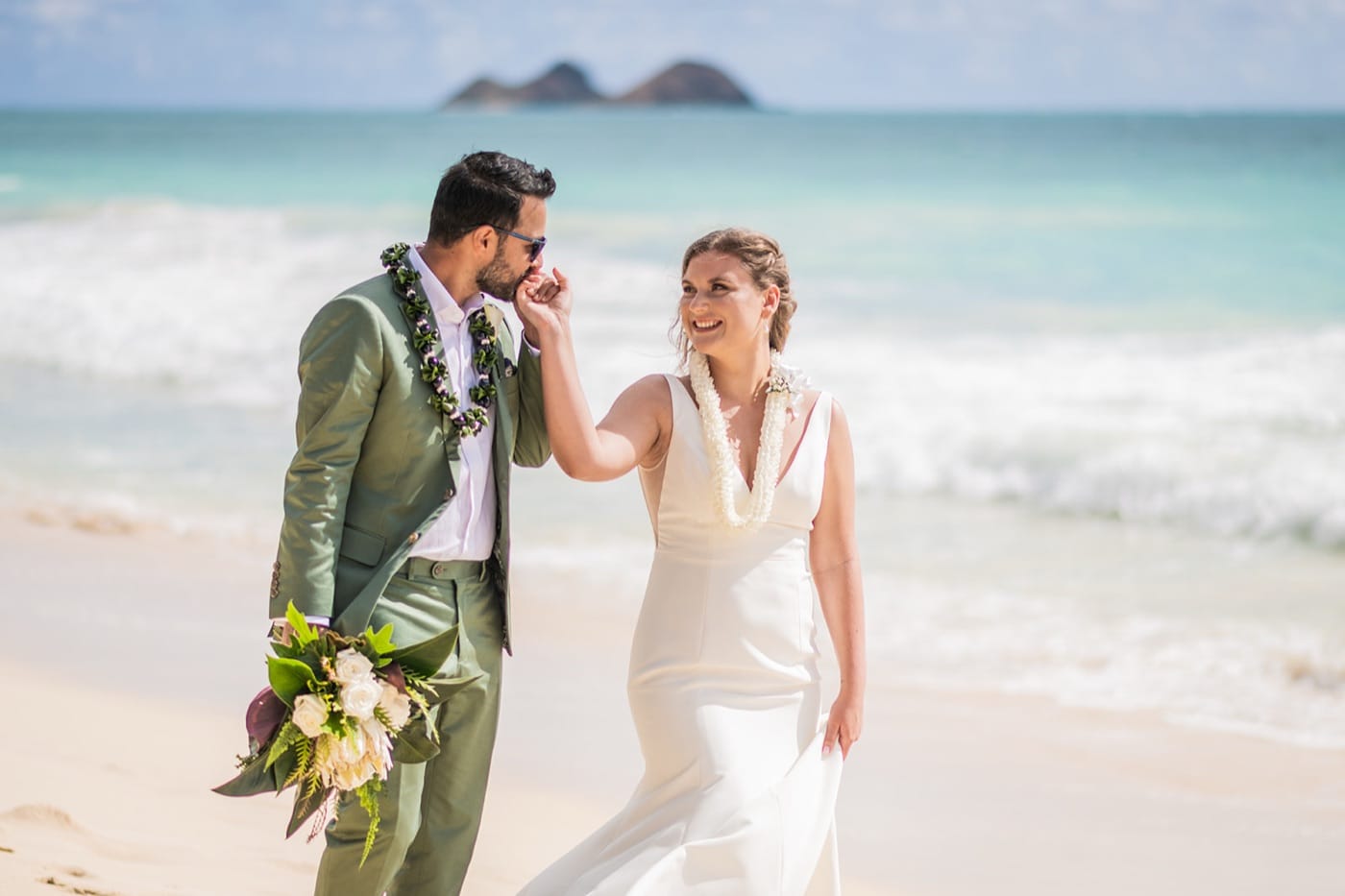 A couple face to face on the sand at Waimanalo Beach on their Oahu elopement day