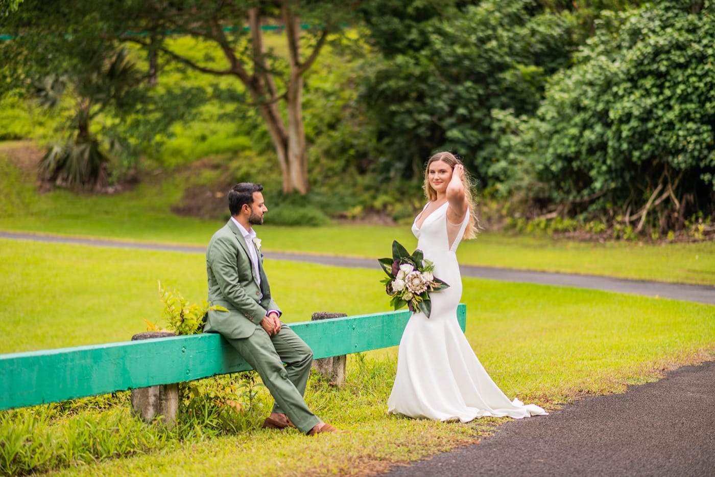 A couple on the lawn at Ho'omaluhia Botanical Garden on their Oahu elopement day