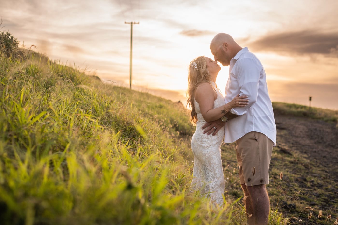 A couple on the North Shore, the ocean behind, on an Oahu elopement day