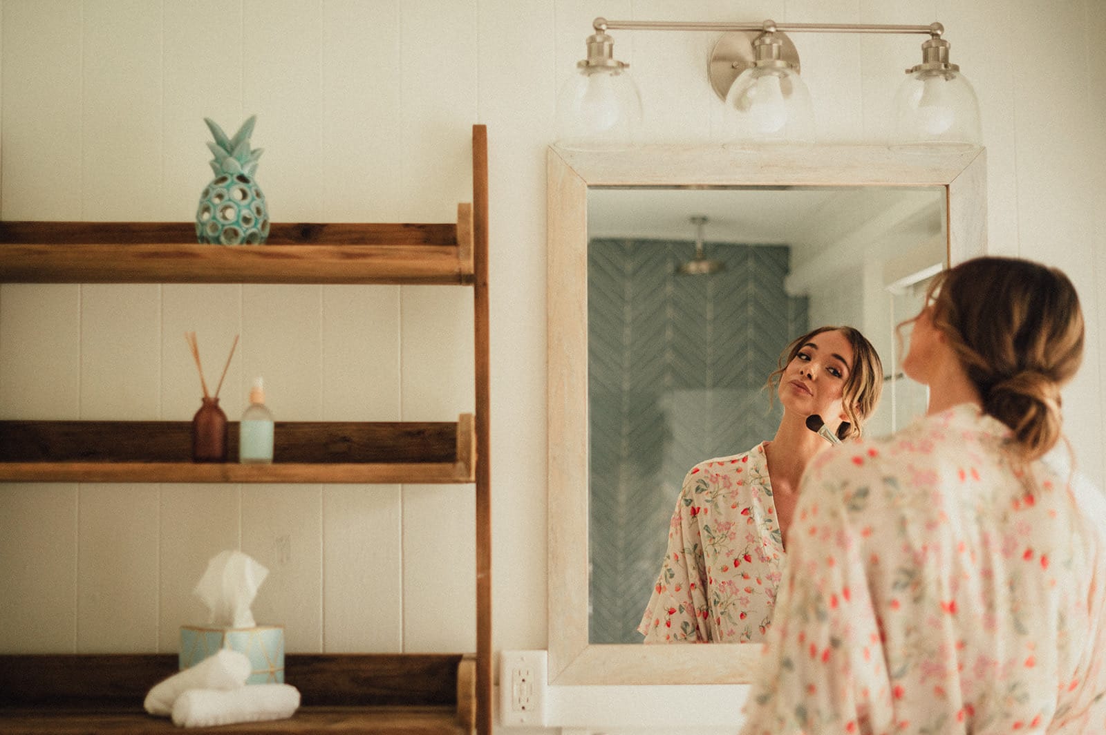 Getting ready in front of the mirror the morning of an Oahu elopement
